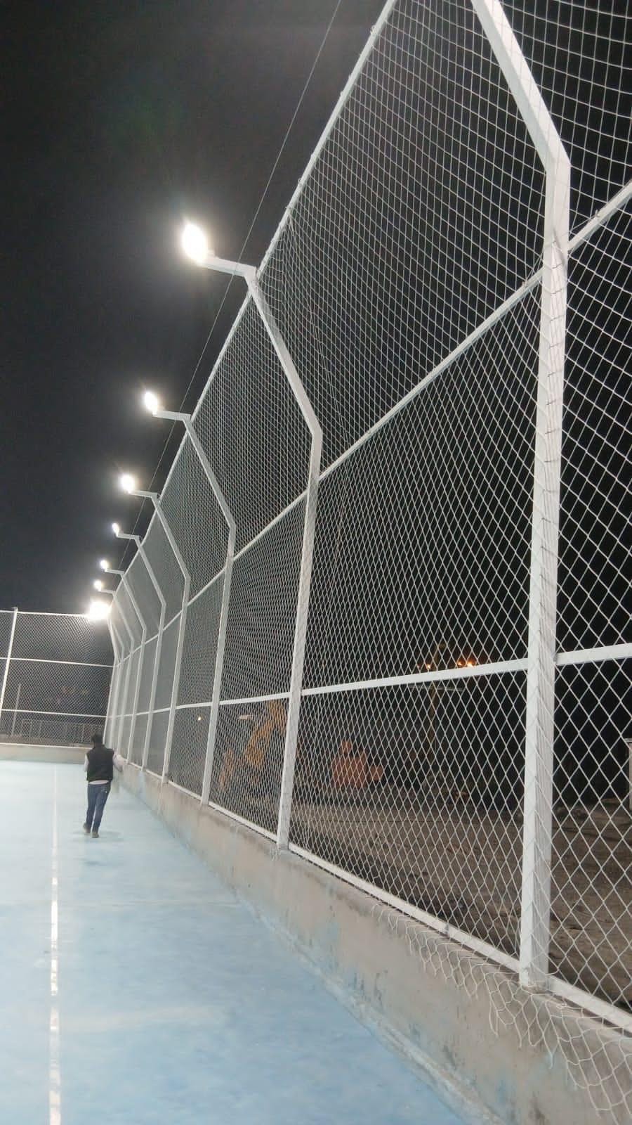 Floodlit court with white perimeter netting installed by TurfFix Pro in Lebanon