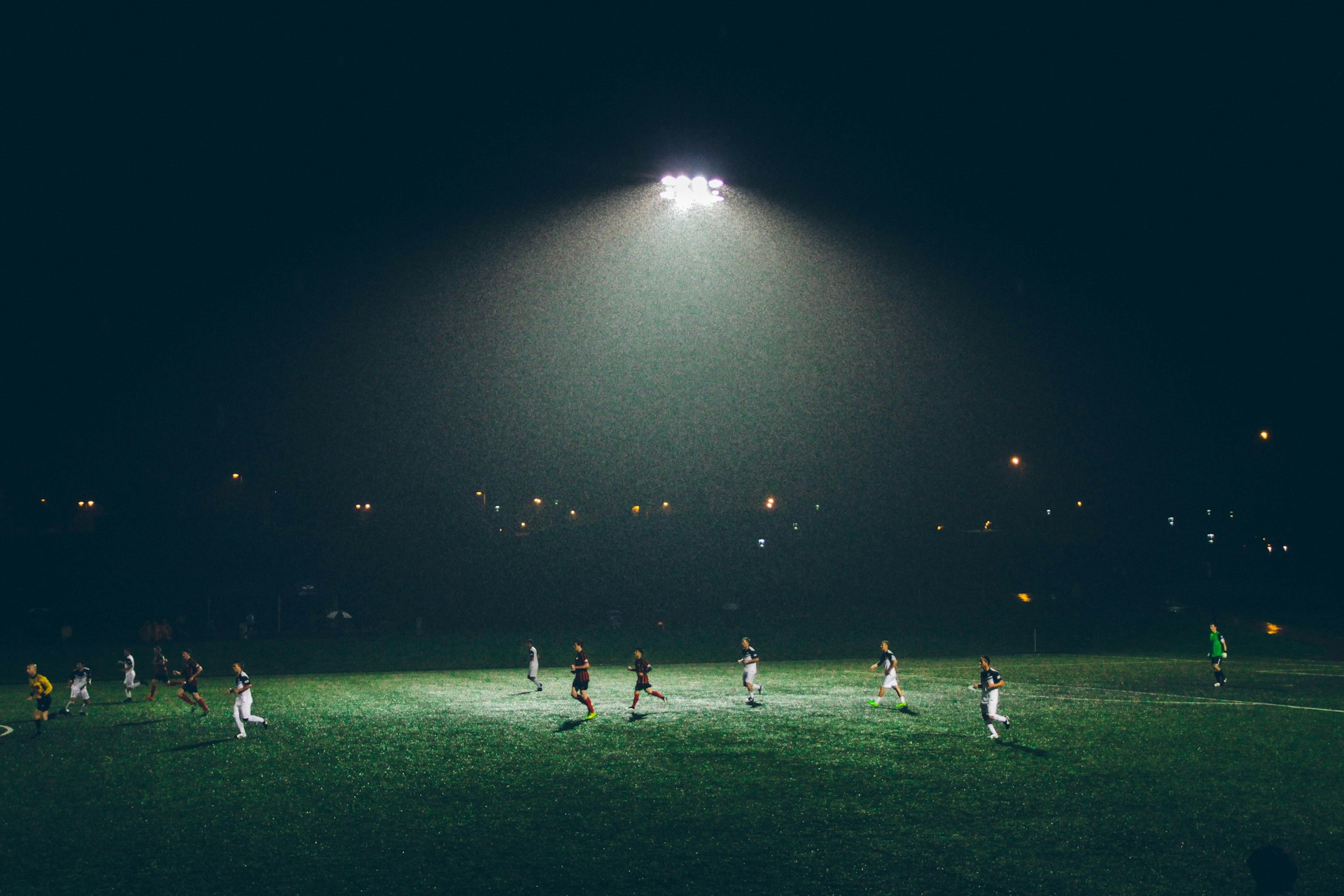 Football pitch under floodlights at night