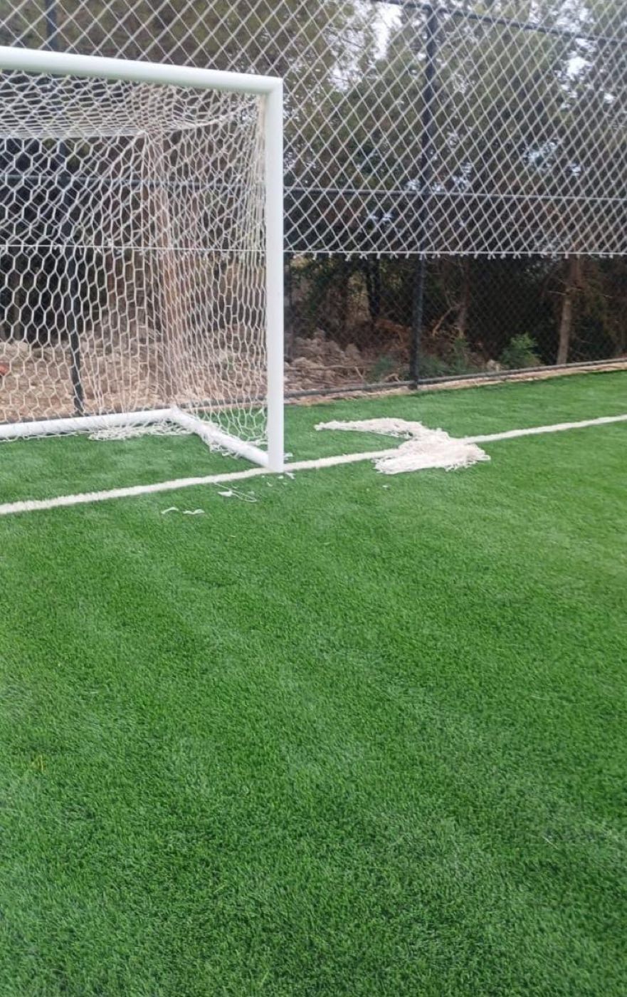 New goal net on a green artificial turf football pitch in Lebanon