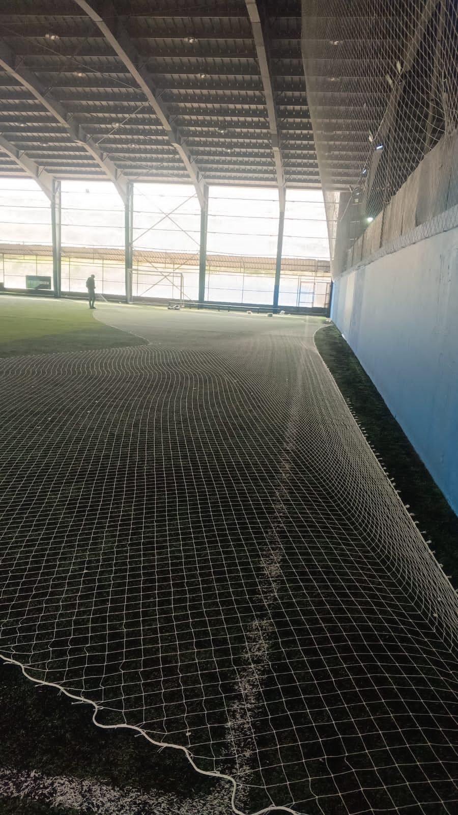 Netting laid over turf inside a covered indoor pitch in Lebanon